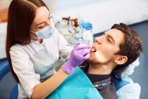 Female dentist working on a patient's teeth using the latest in laser dentistry technology