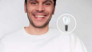 Smiling man with a dental implant graphic highlighting one tooth replaced with an implant.